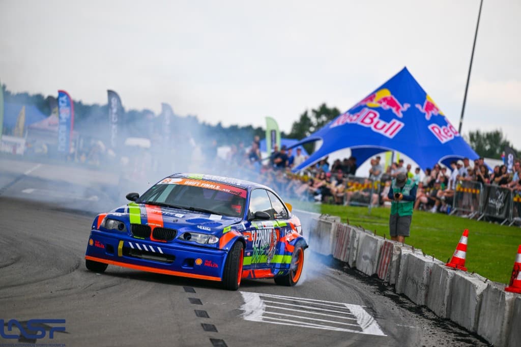 Drift car on track with tyre smoke, GRIPGP moment