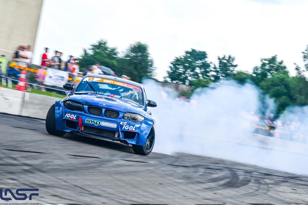 Blue BMW drift car with a smoke trail