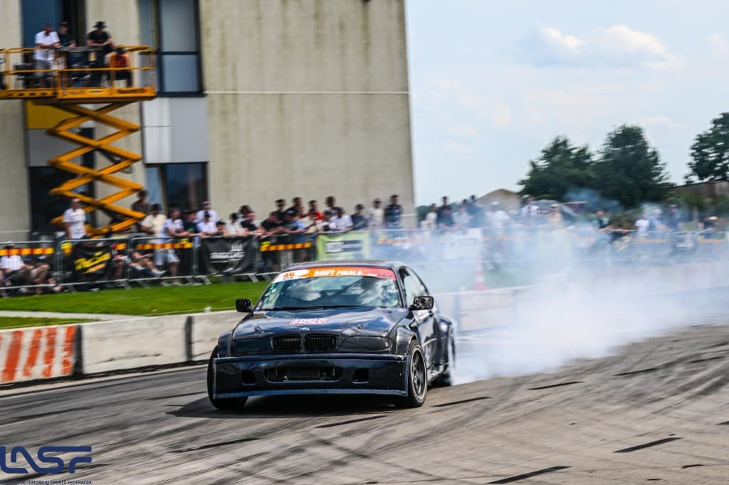 Black BMW drift car with spectators in the background